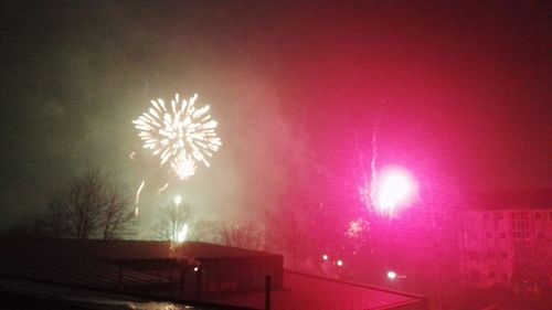Low angle view of firework display at night