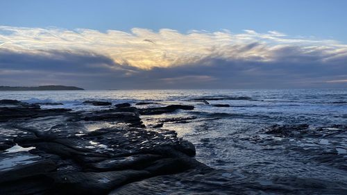 Scenic view of sea against sky during sunrise