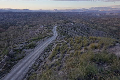 High angle view of road amidst land against sky