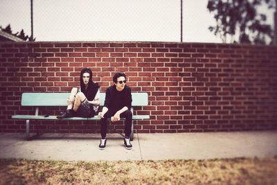 Full length of woman sitting on bench