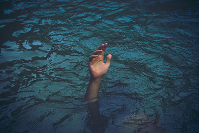 High angle view of person drowning in lake