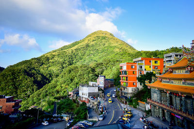 High angle view of street amidst buildings against sky