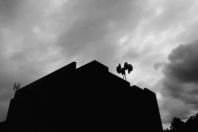 Low angle view of building against cloudy sky