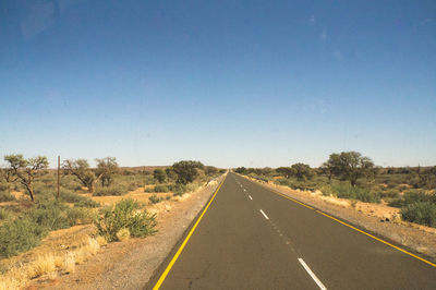 Road against clear blue sky