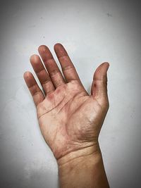 Close-up of human hand against white background