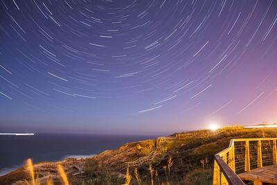 Lightning over sea against sky at night