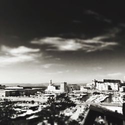 Tilt-shift image of cityscape against sky