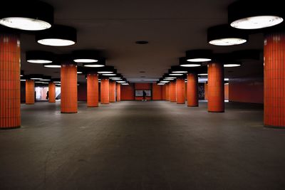 Orange columns at illuminated subway station