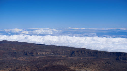 Scenic view of mountain against blue sky