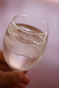 Close-up of hand holding glass of juice