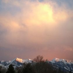 Scenic view of snowcapped mountains against sky during sunset