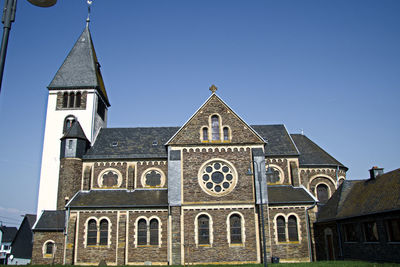 Low angle view of building against clear blue sky