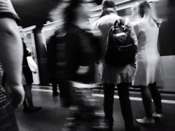 People walking on street in city at night