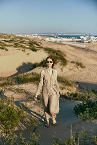 Rear view of woman standing at beach