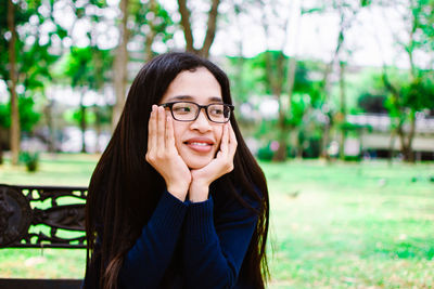 Young woman sitting at park