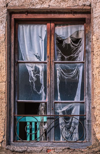 Closed window of abandoned house