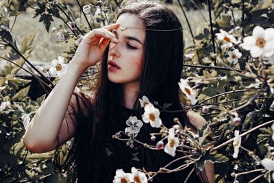 Portrait of woman holding flower