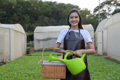 Portrait of a smiling young woman standing outdoors