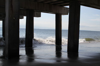 Scenic view of sea against sky seen through pier