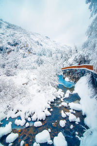 View of footbridge over snow covered land during winter