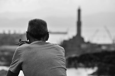 Rear view of man smoking cigarette