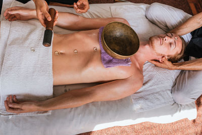 High angle view of woman resting on bed