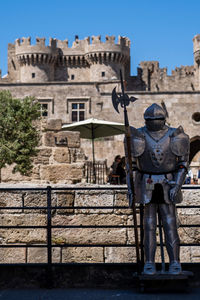 An old armor of the knights and in background the palace of the grand master.