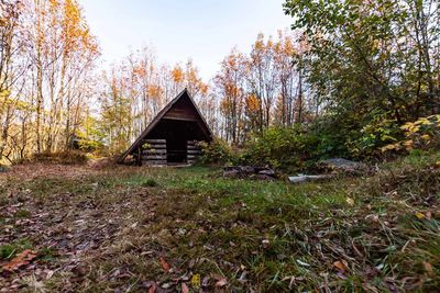 Built structure on field against trees during autumn