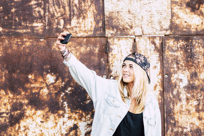 Portrait of young woman photographing
