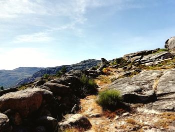 Rock formations on landscape against sky