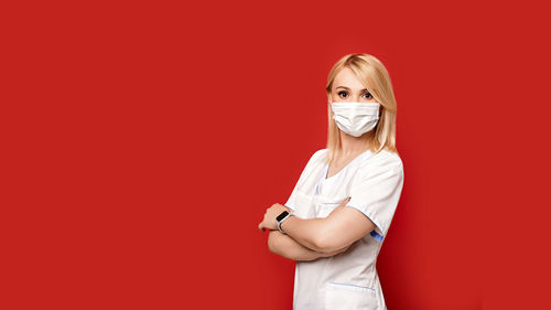 Portrait of a beautiful young woman over red background