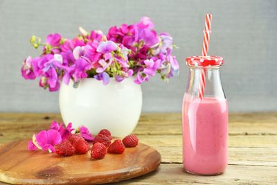 Close-up of raspberries and drink on table