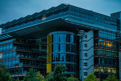 Low angle view of modern building against clear blue sky