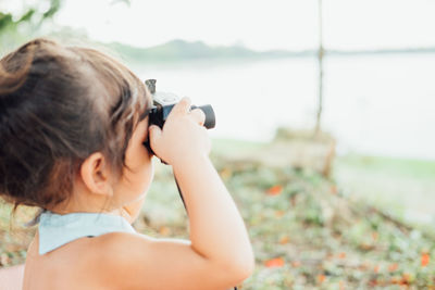 Girl photographing from camera