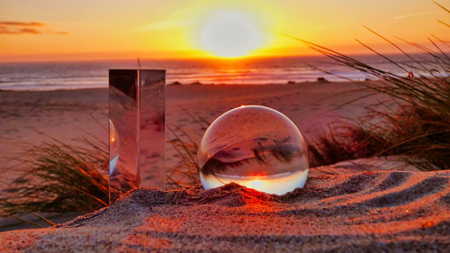 Close-up of cristal ball on beach