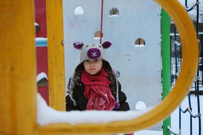 Full length of girl standing against wall