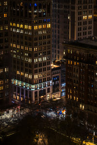 High angle view of illuminated buildings in city at night