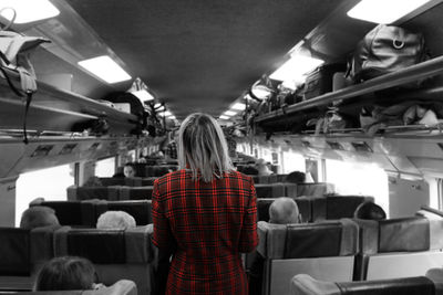 Rear view of person sitting in bus