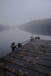 Pier over lake against sky