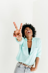 Mid adult woman standing against white background