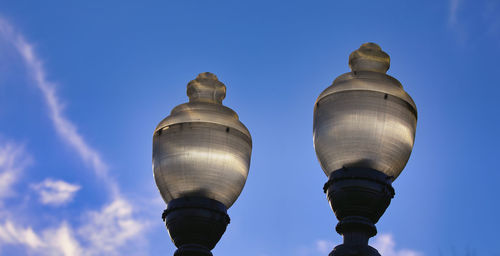 Low angle view of street light against blue sky