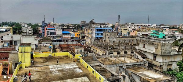 High angle view of buildings and street against sky