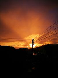 Silhouette landscape against sky during sunset