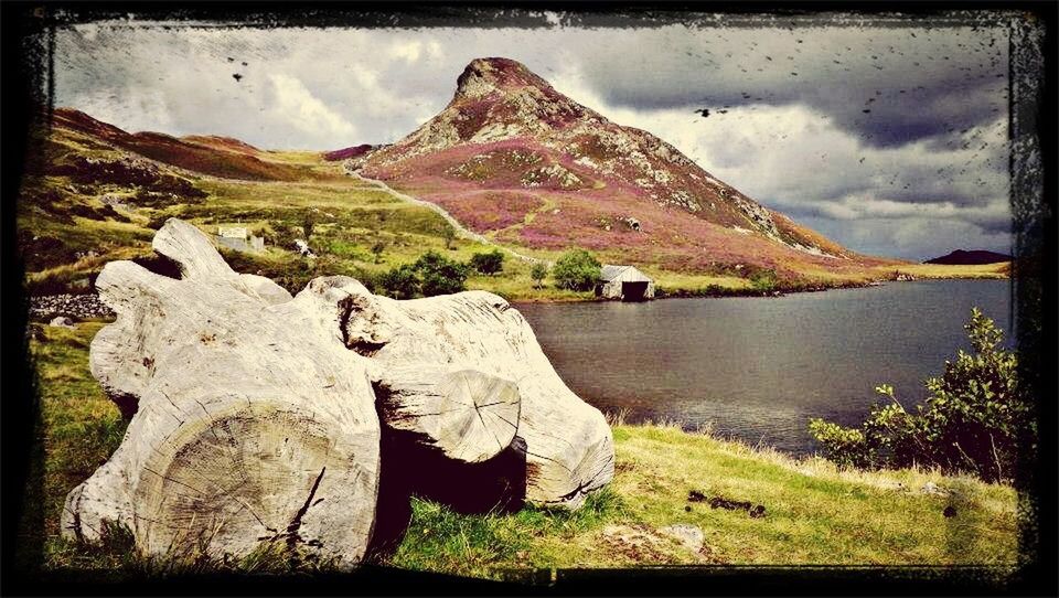 transfer print, mountain, auto post production filter, sky, tranquil scene, tranquility, water, scenics, mountain range, beauty in nature, nature, lake, cloud - sky, grass, cloud, landscape, non-urban scene, rock formation, rock - object, idyllic