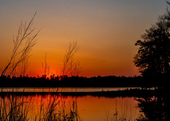 Scenic view of lake against romantic sky at sunset