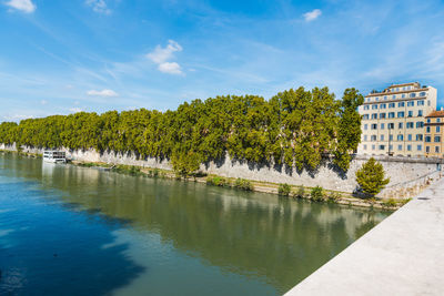 Scenic view of lake by building against sky