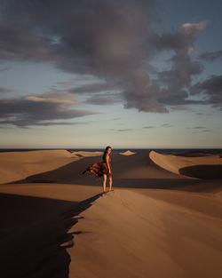 Woman on beach against sky