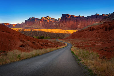 Empty road passing through rocky mountains