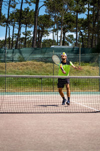 Rear view of woman playing tennis