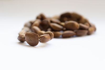 Close-up of coffee beans against white background